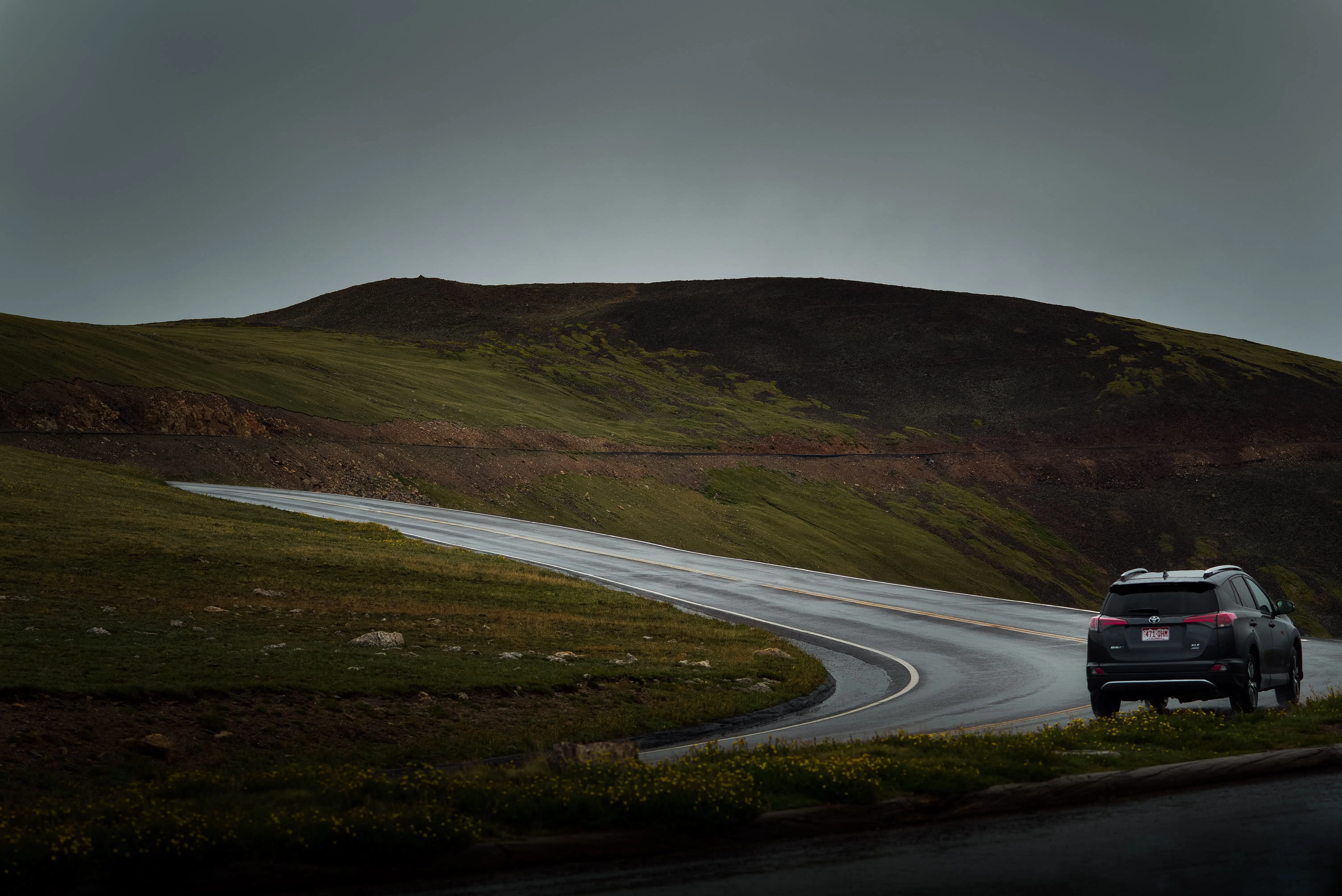 Moody image of car driving down a road