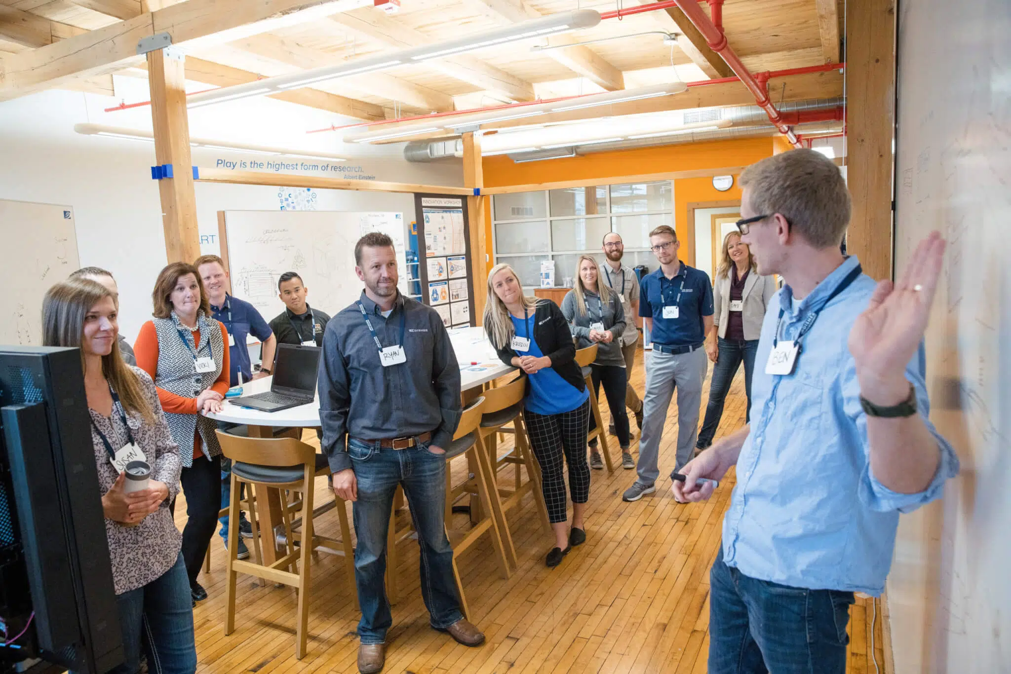 An industrial designer points to a whiteboard