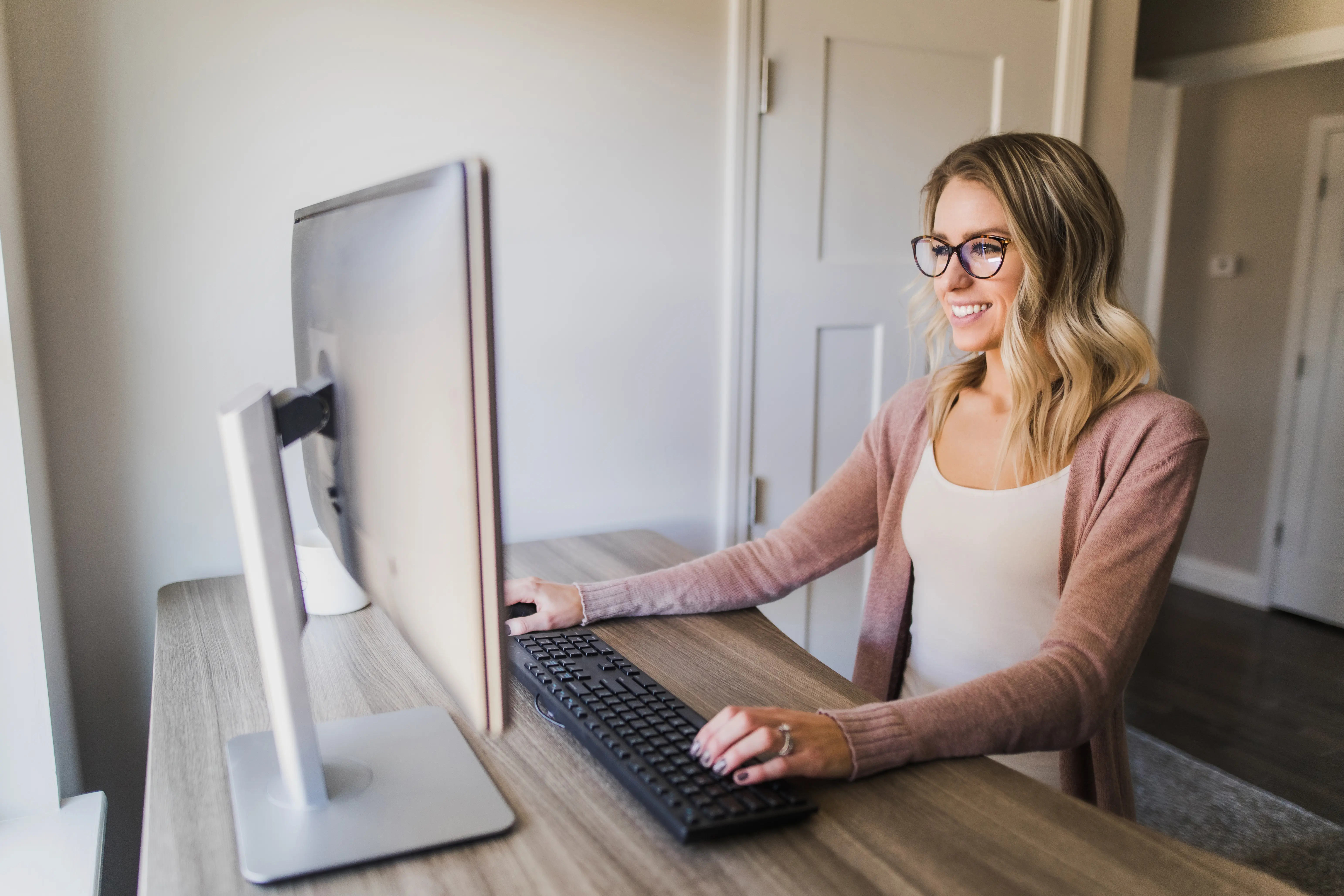 Woman at adjustable desk, testing