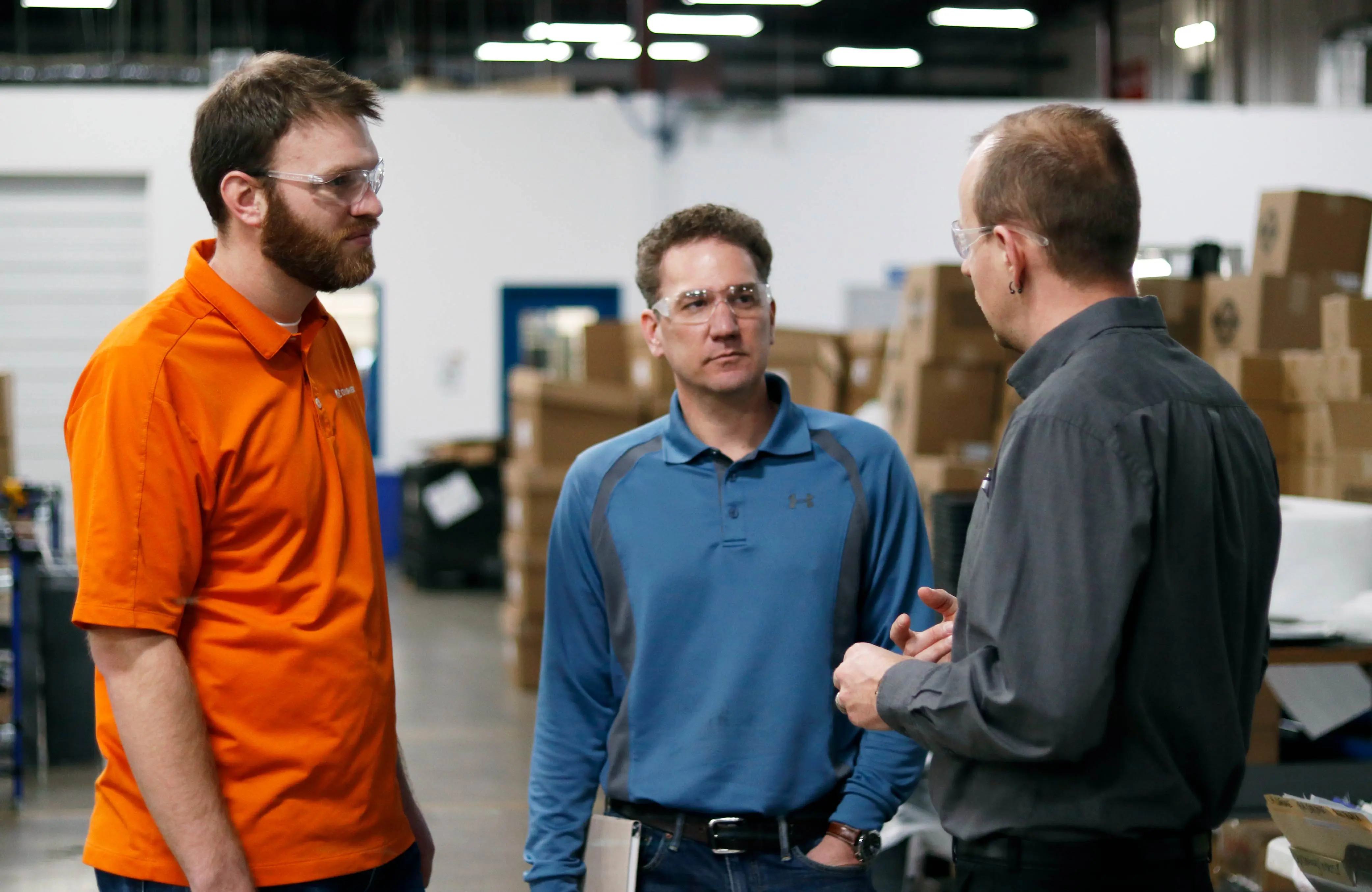 Engineers talking in a manufacturing warehouse