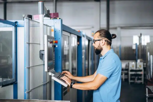 Engineer working with IoT in a manufacturing plant