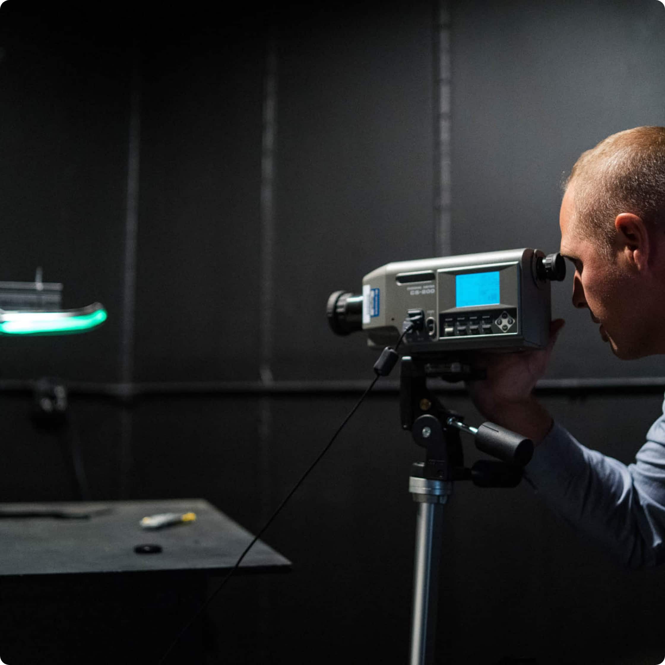 An engineer looking through a light meter