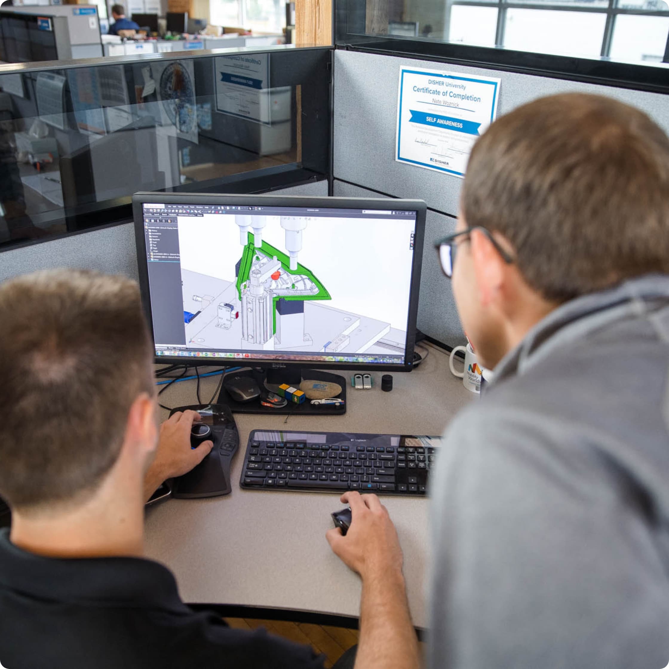 Two engineerings looking at CAD on a computer