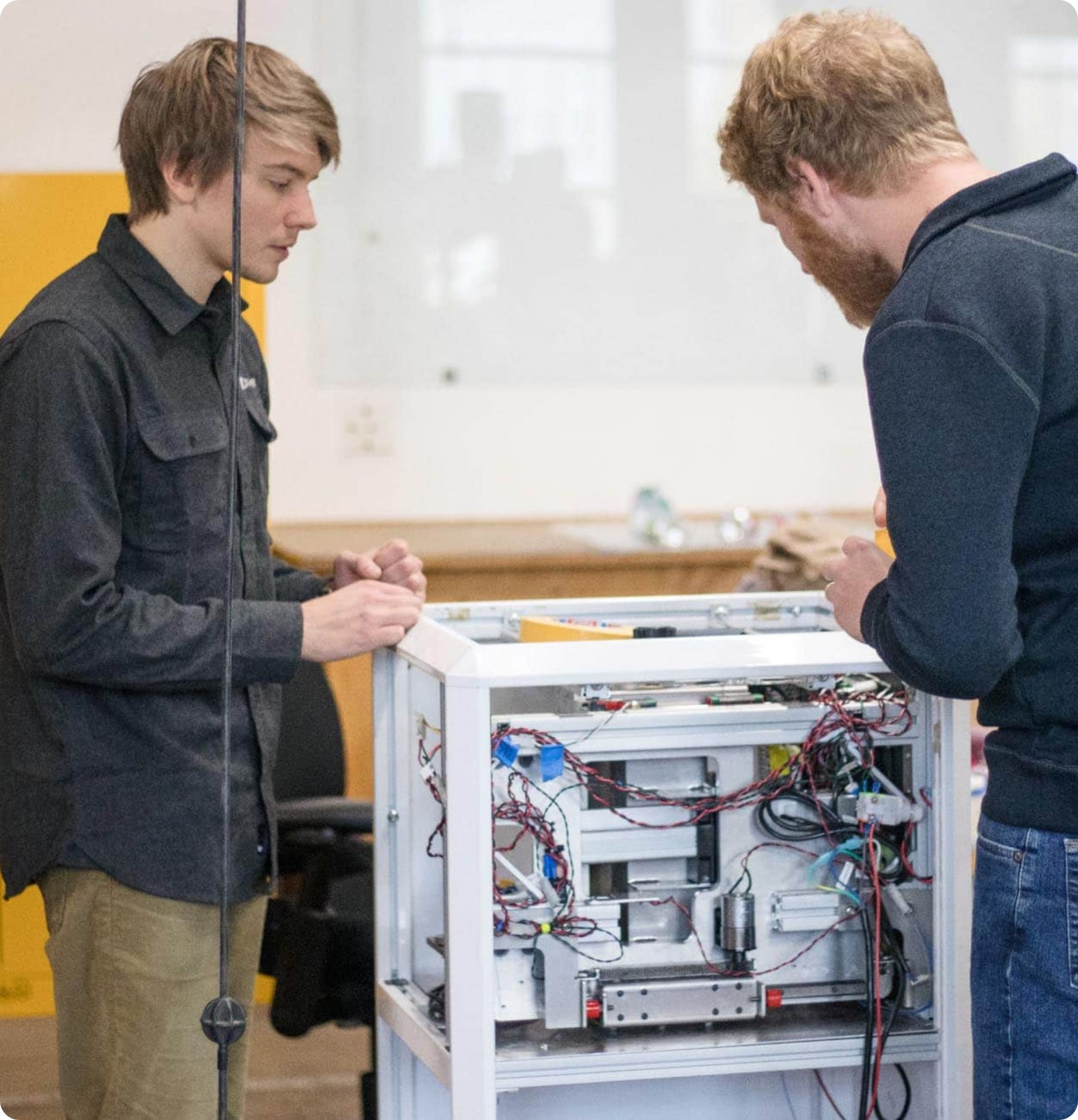 Two electronics engineers working on wiring a prototype