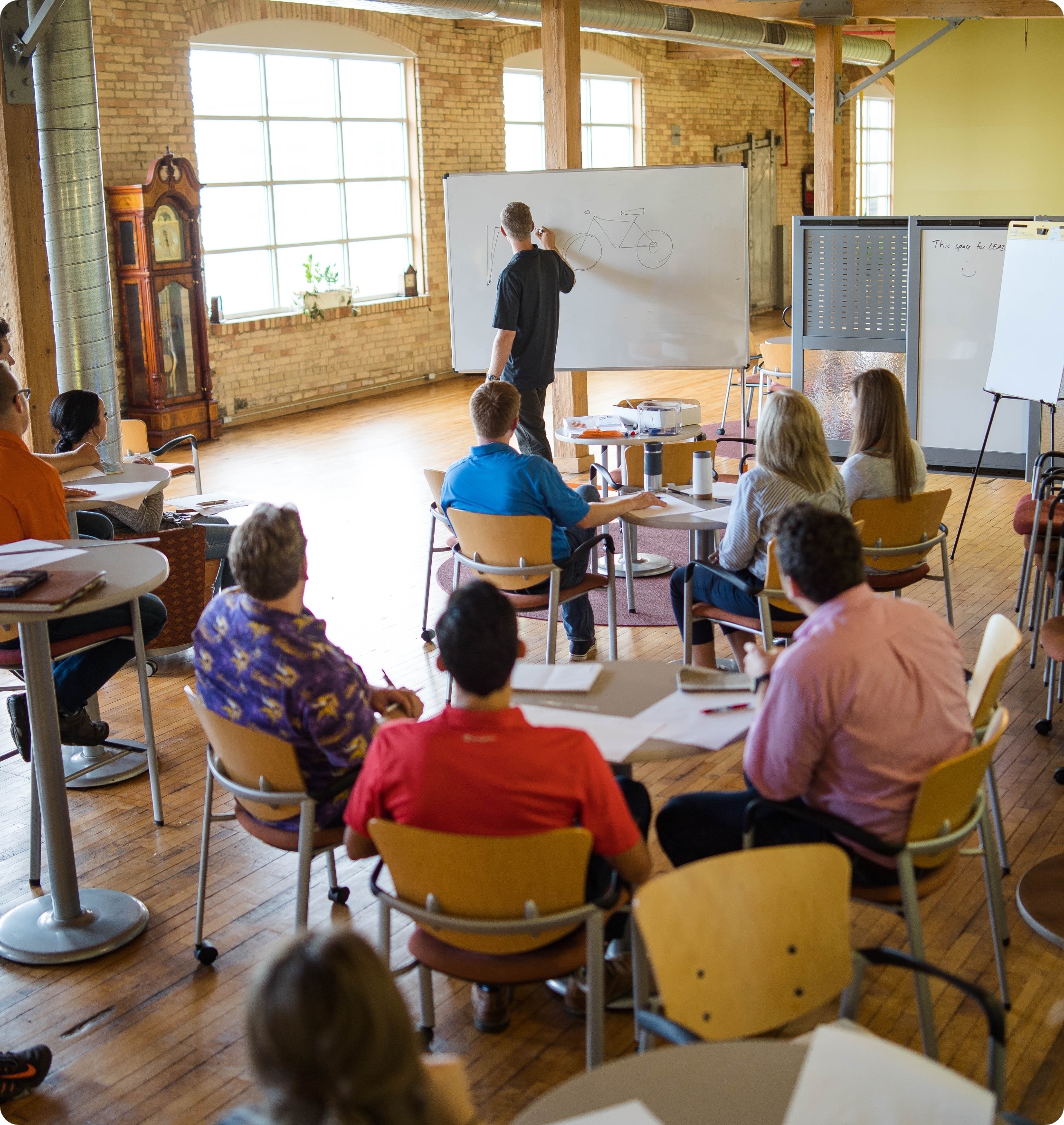 An industrial designer teaching a class to draw
