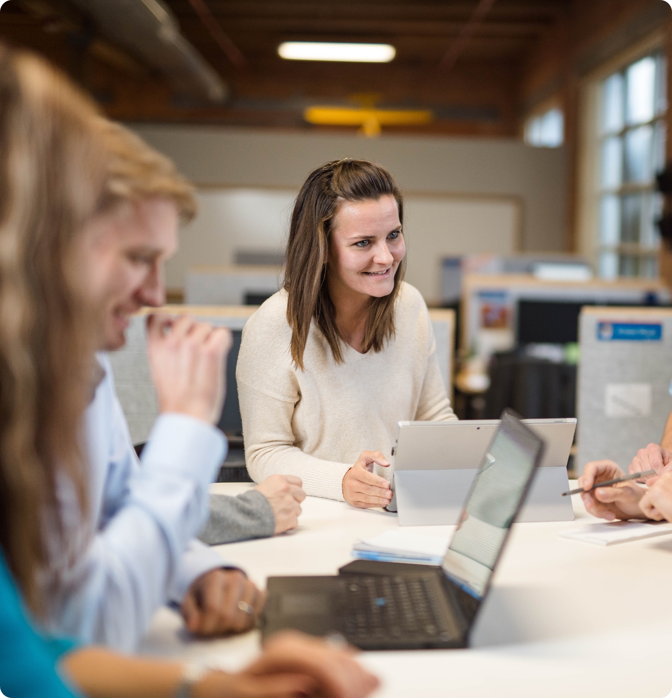 A woman smiles in a meeting
