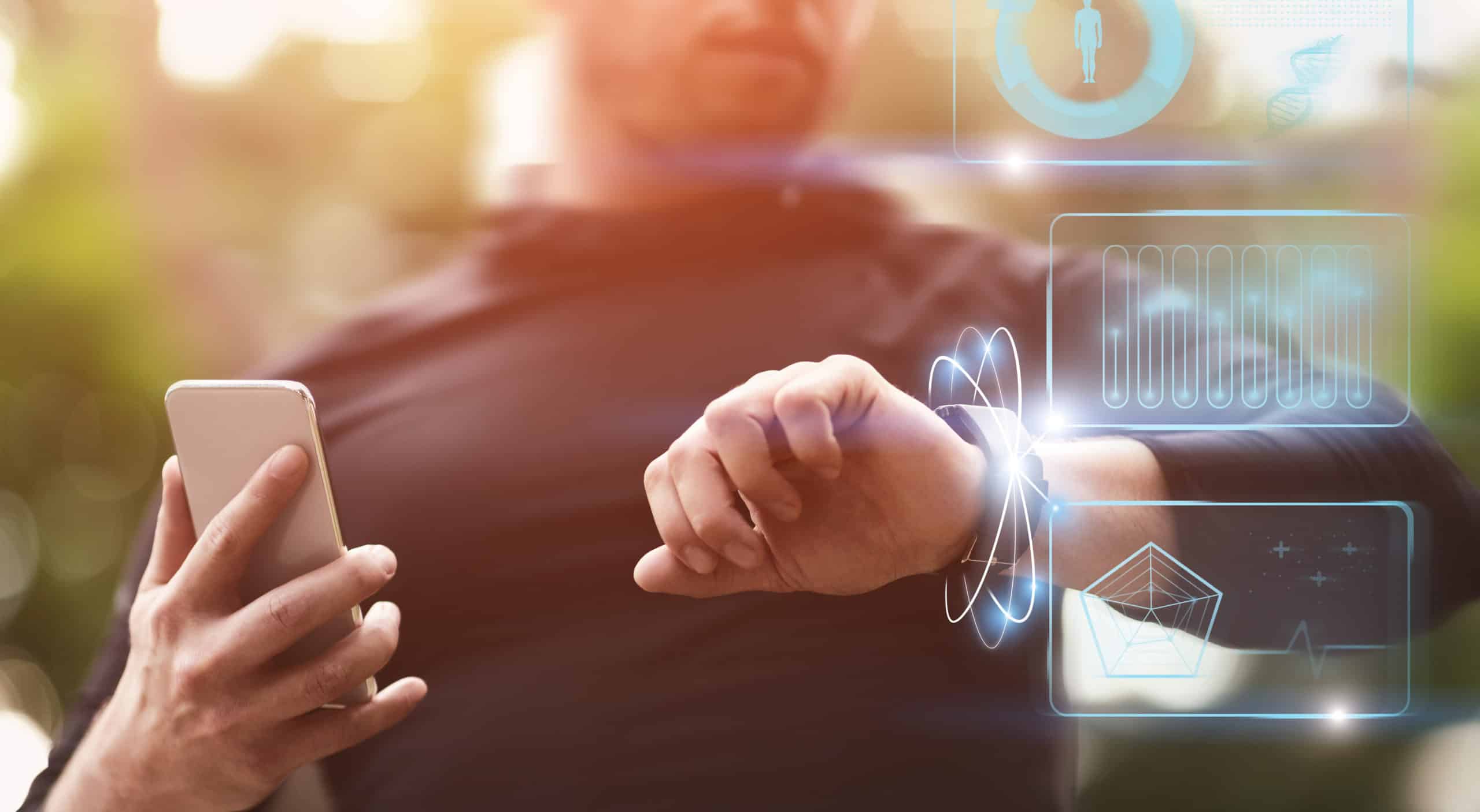 Modern Technology Concept. Guy holding smart phone checking wristband outdoors, panorama, HUD futuristic elements interface
