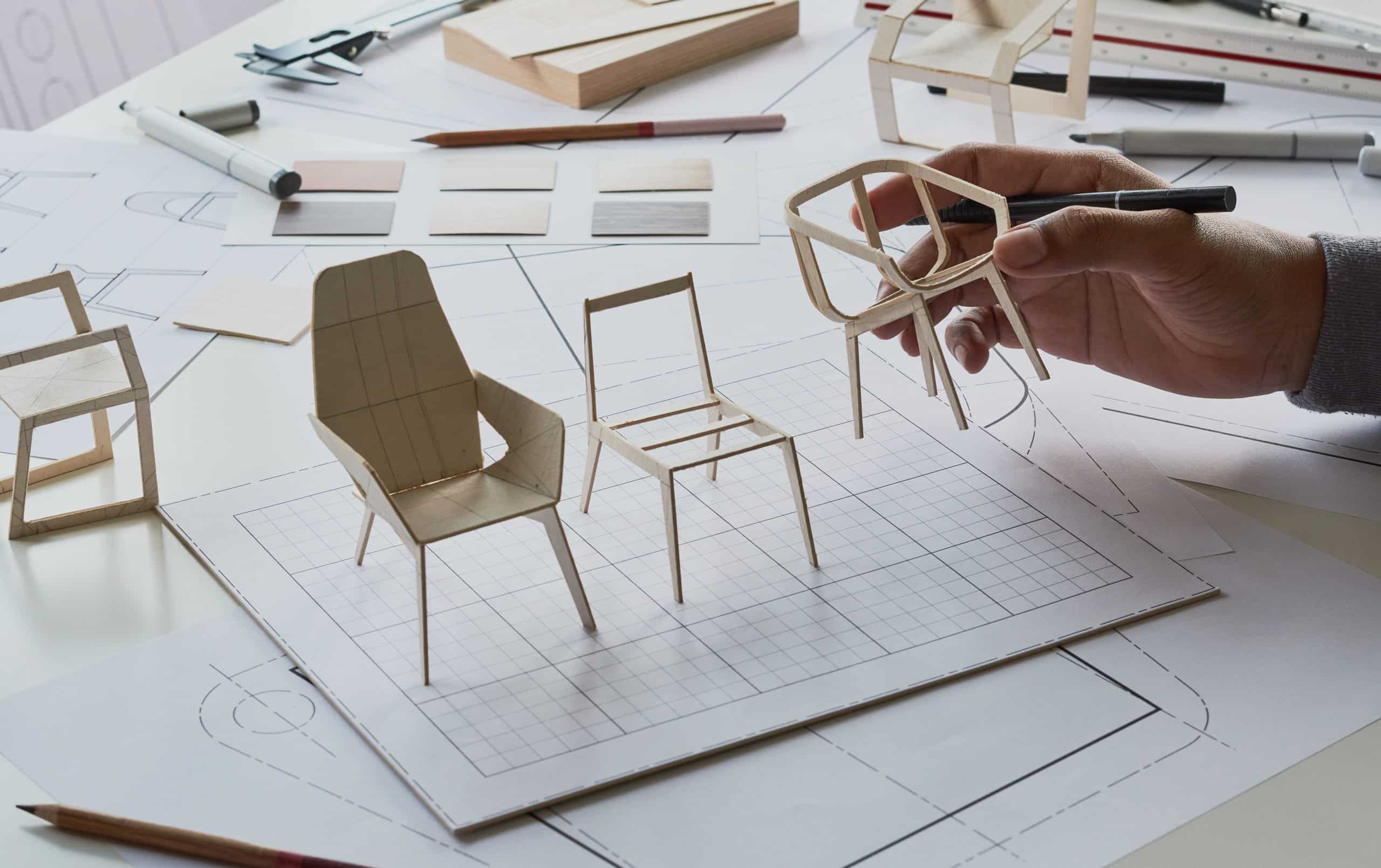 Designer reviewing prototypes of chair designs