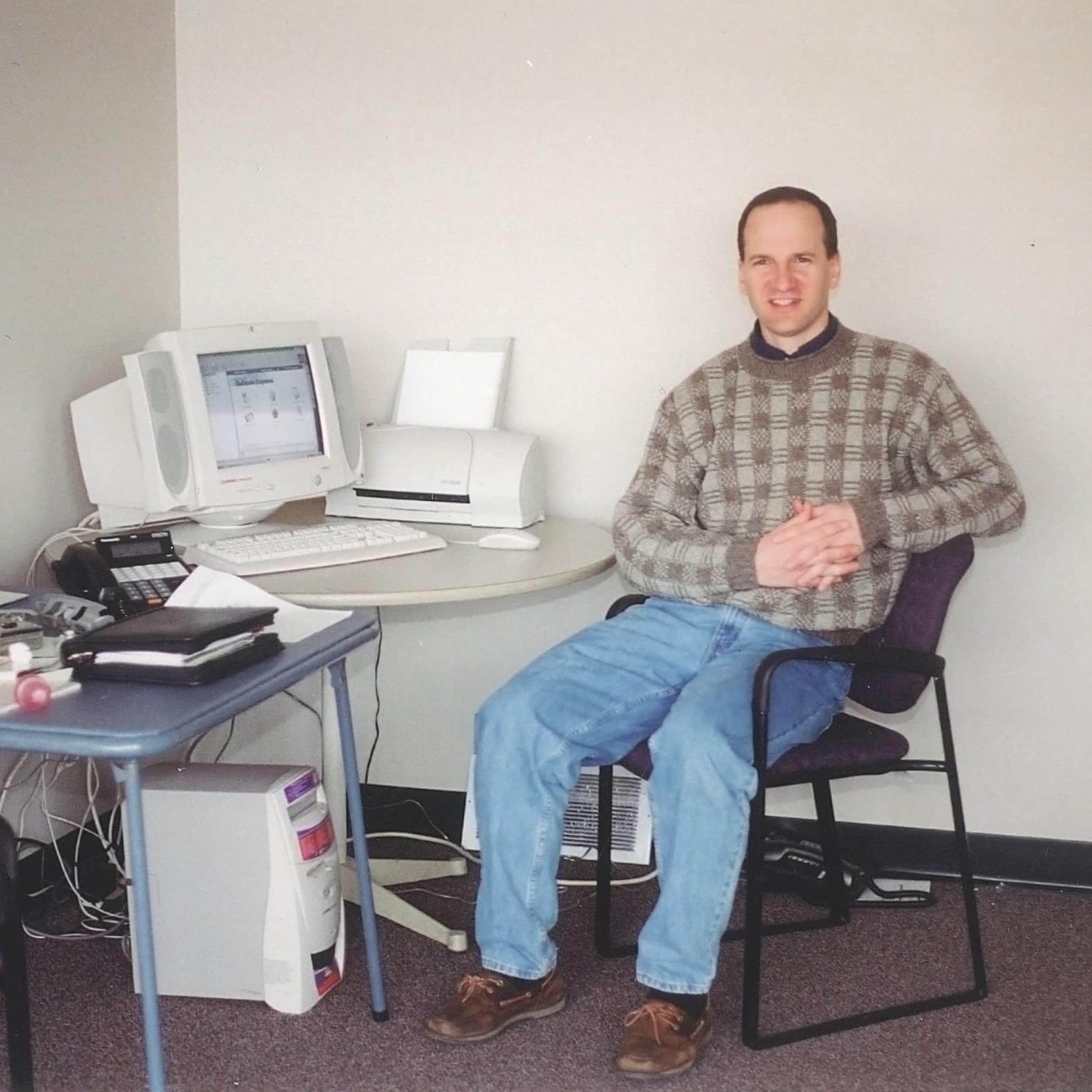 Jeff Disher sitting at a desk on his first day of work