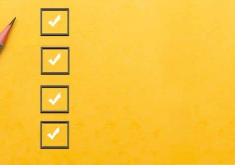 Checklist with pencil on yellow background