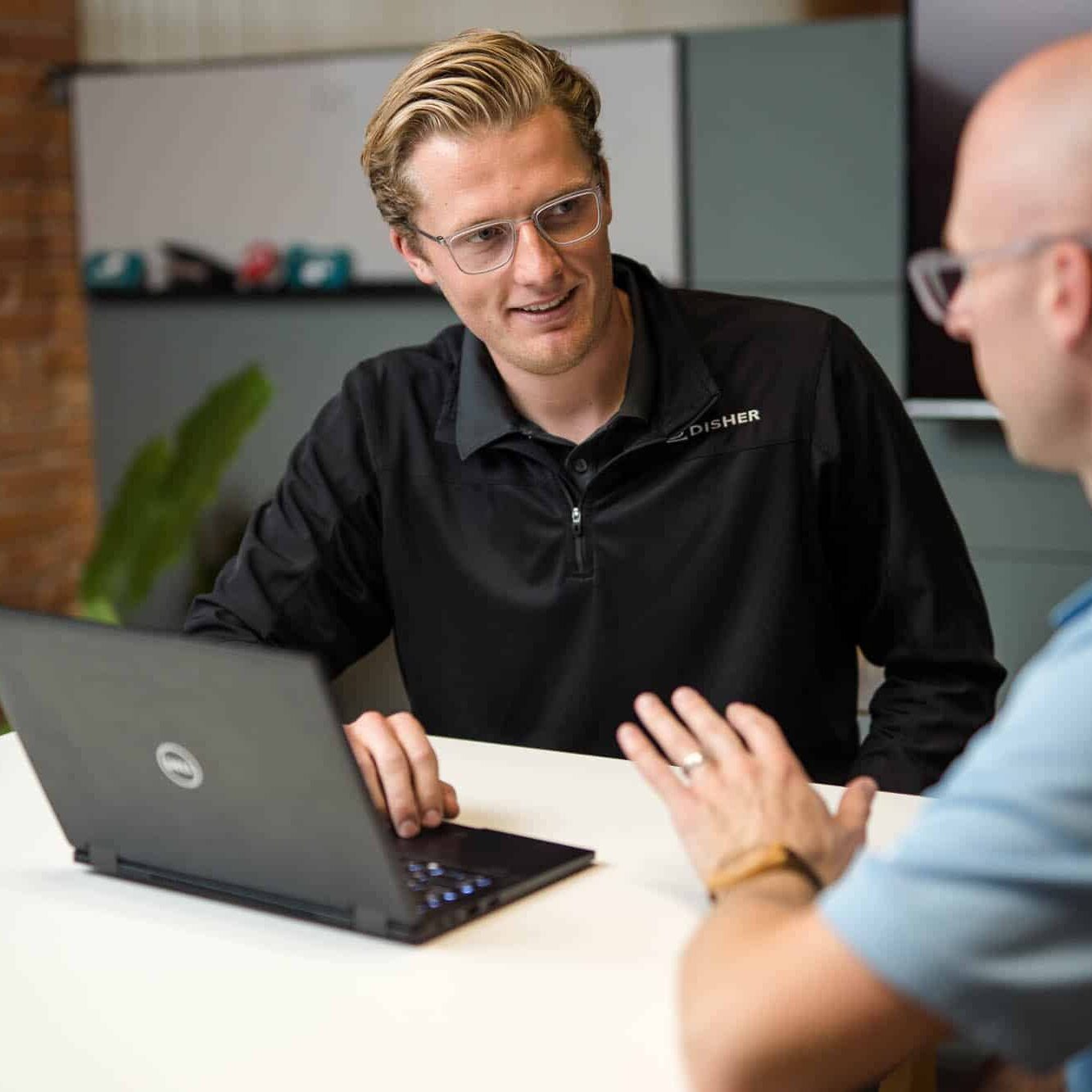 Two recruiters talking by a computer