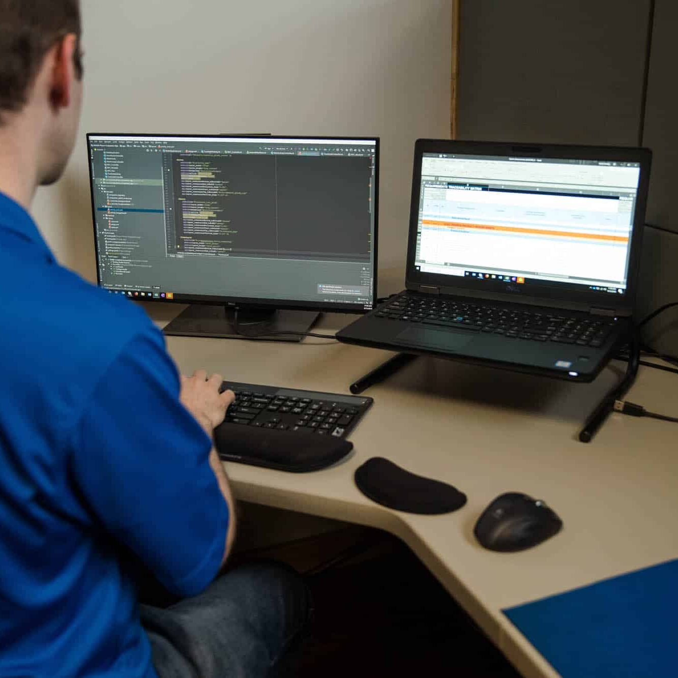 Software Developer writing code on computer