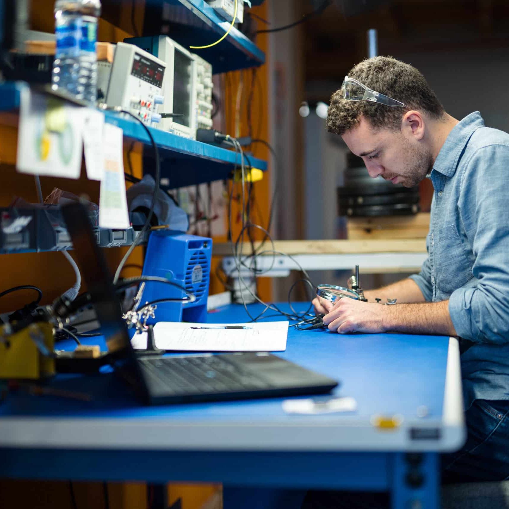 Electronics engineering working in lab