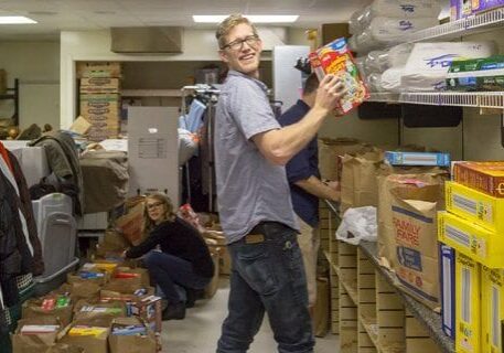 DISHER employee helping in food pantry
