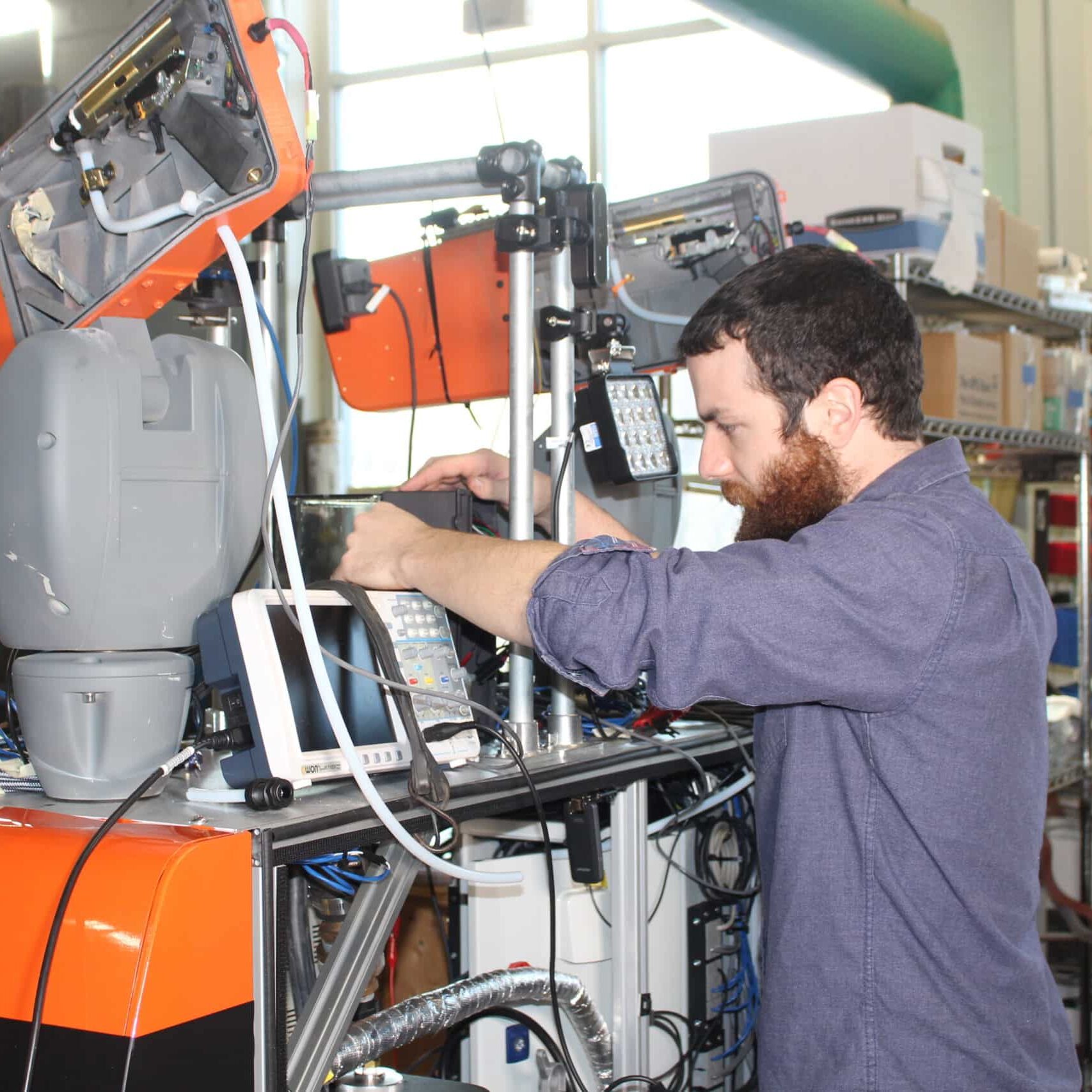 An engineer works on an engineering prototype of an autonomous vehicle