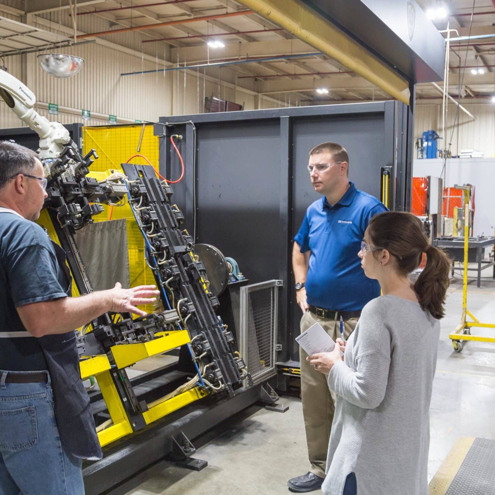 Automation Engineer talking with manufacturing workers