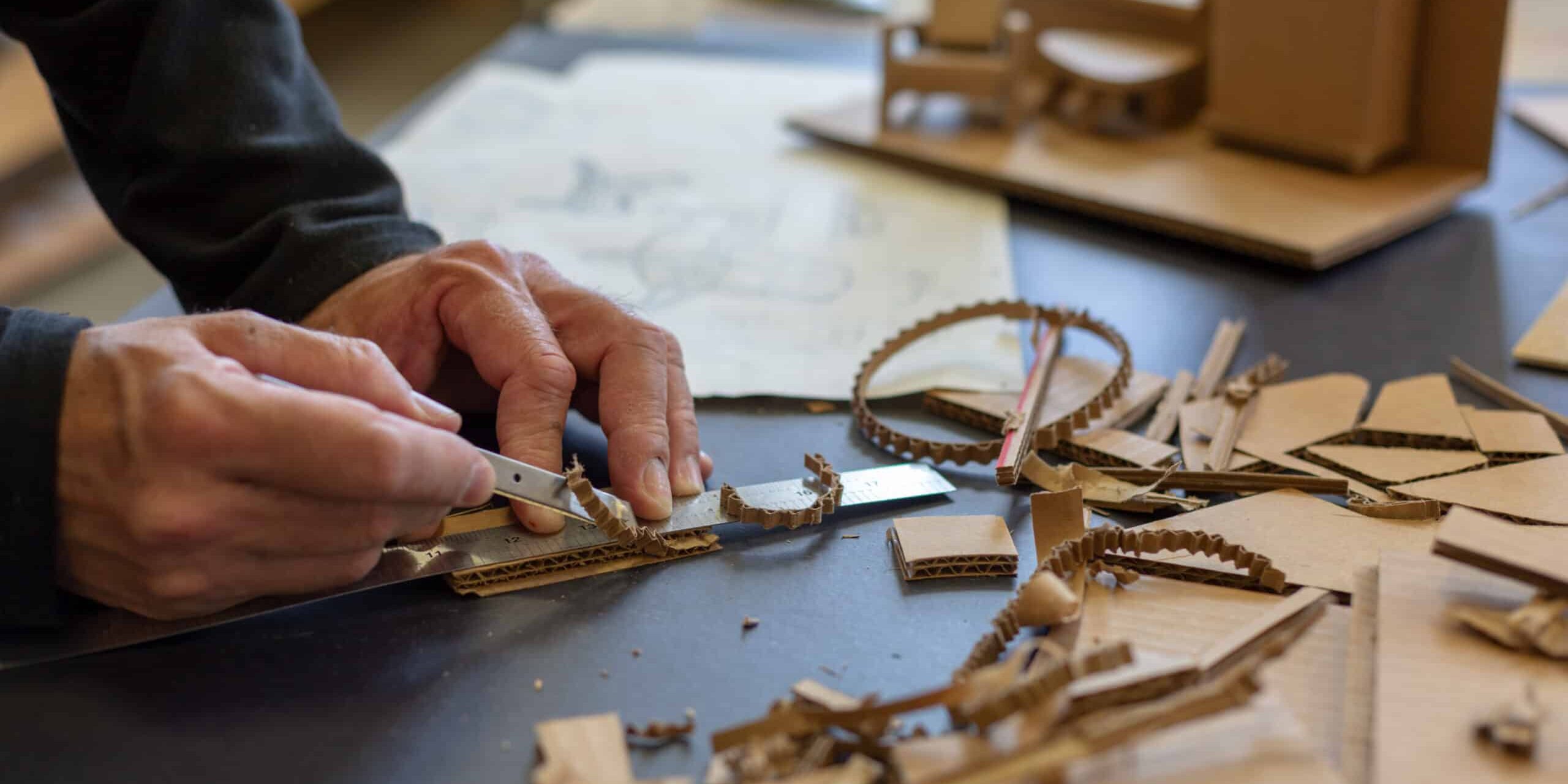 Industrial designer working on rapid prototyping with cardboard