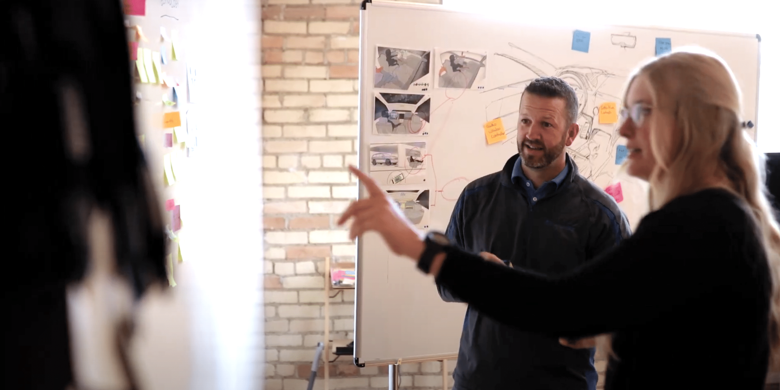 Two people brainstorming with a whiteboard