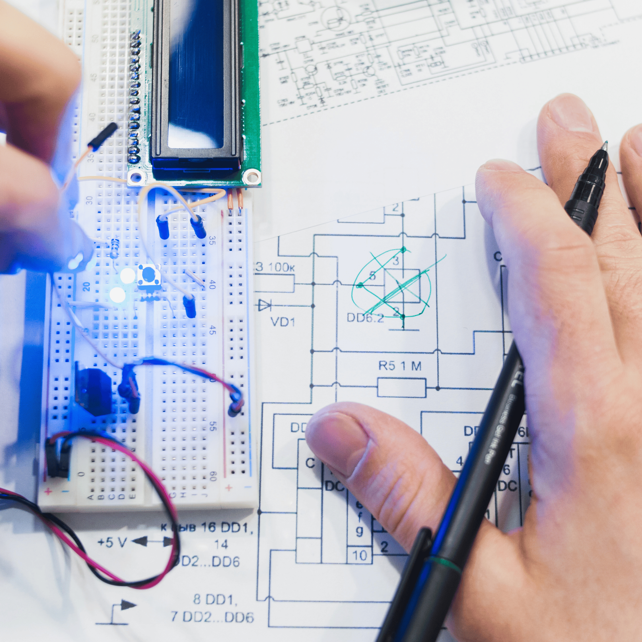A overhead shot of an engineering working on electronics systems design