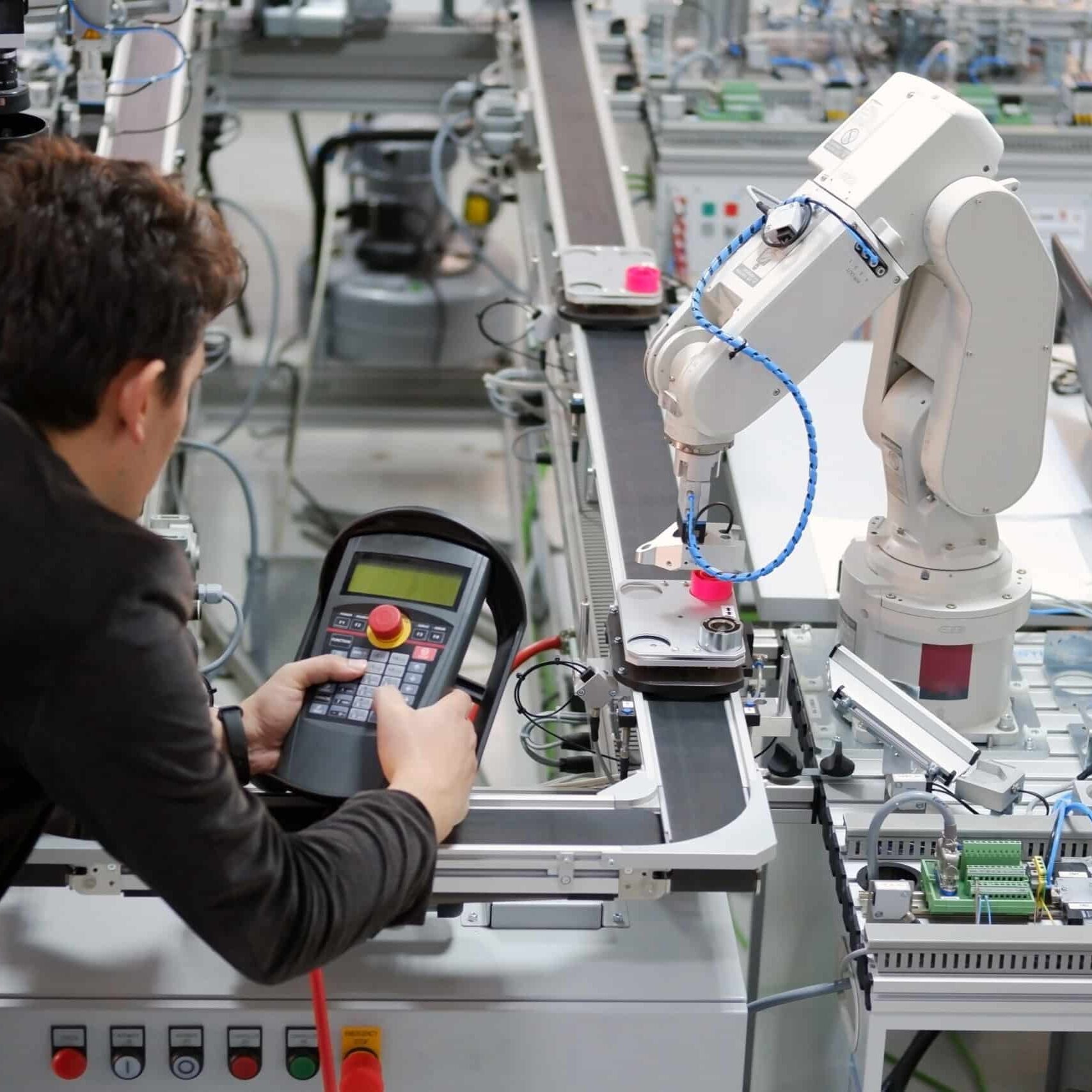 A person working on an automated machine in a factory