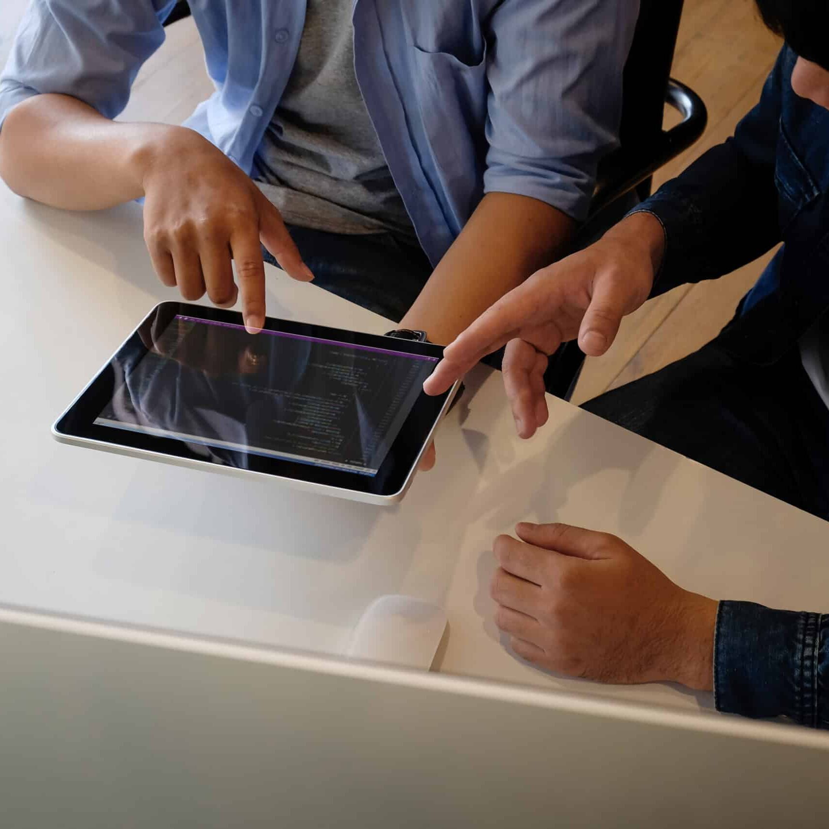 Two people looking at an ipad doing usability testing